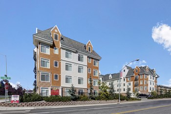 The exterior of the building with uncovered parking for guests and residents Property Image